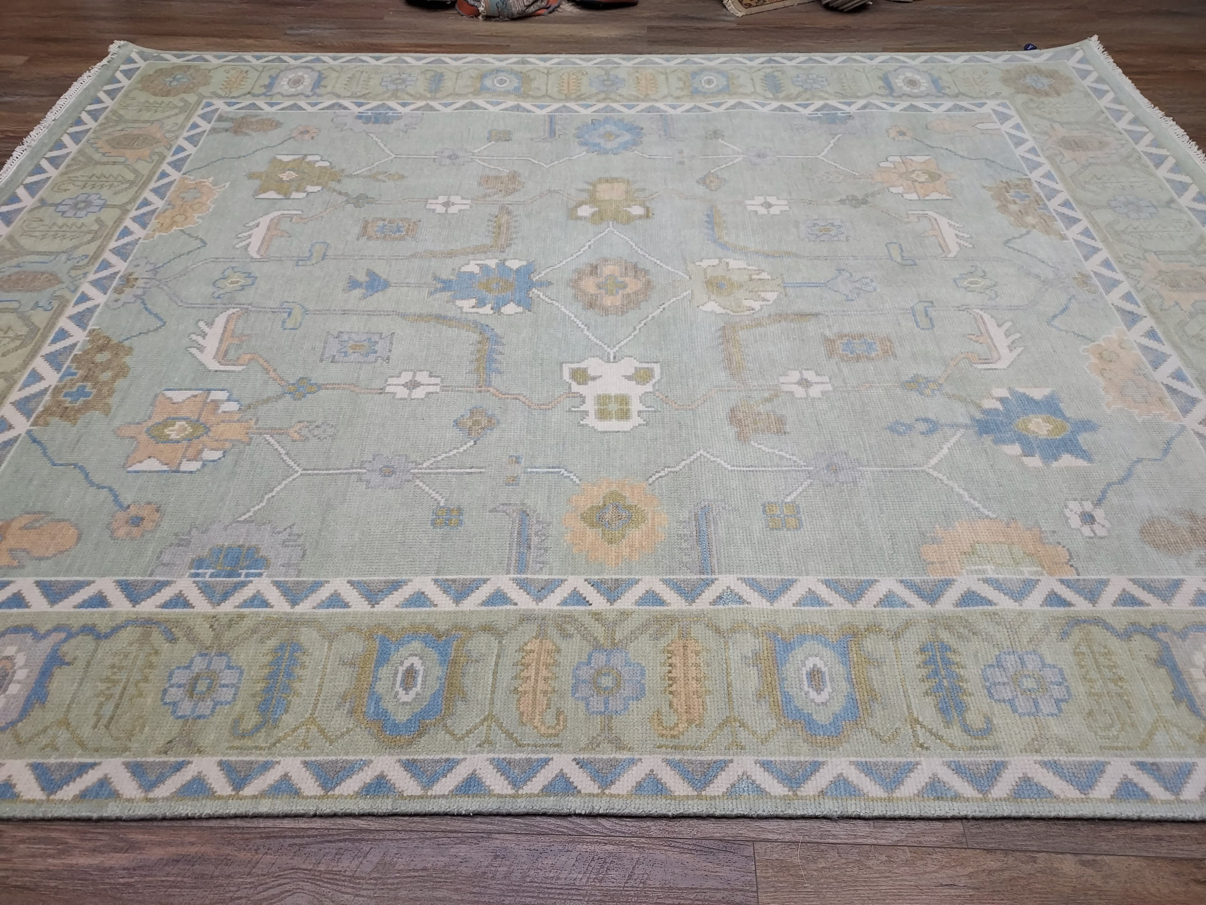 Decorative rug with intricate patterns on a wooden floor