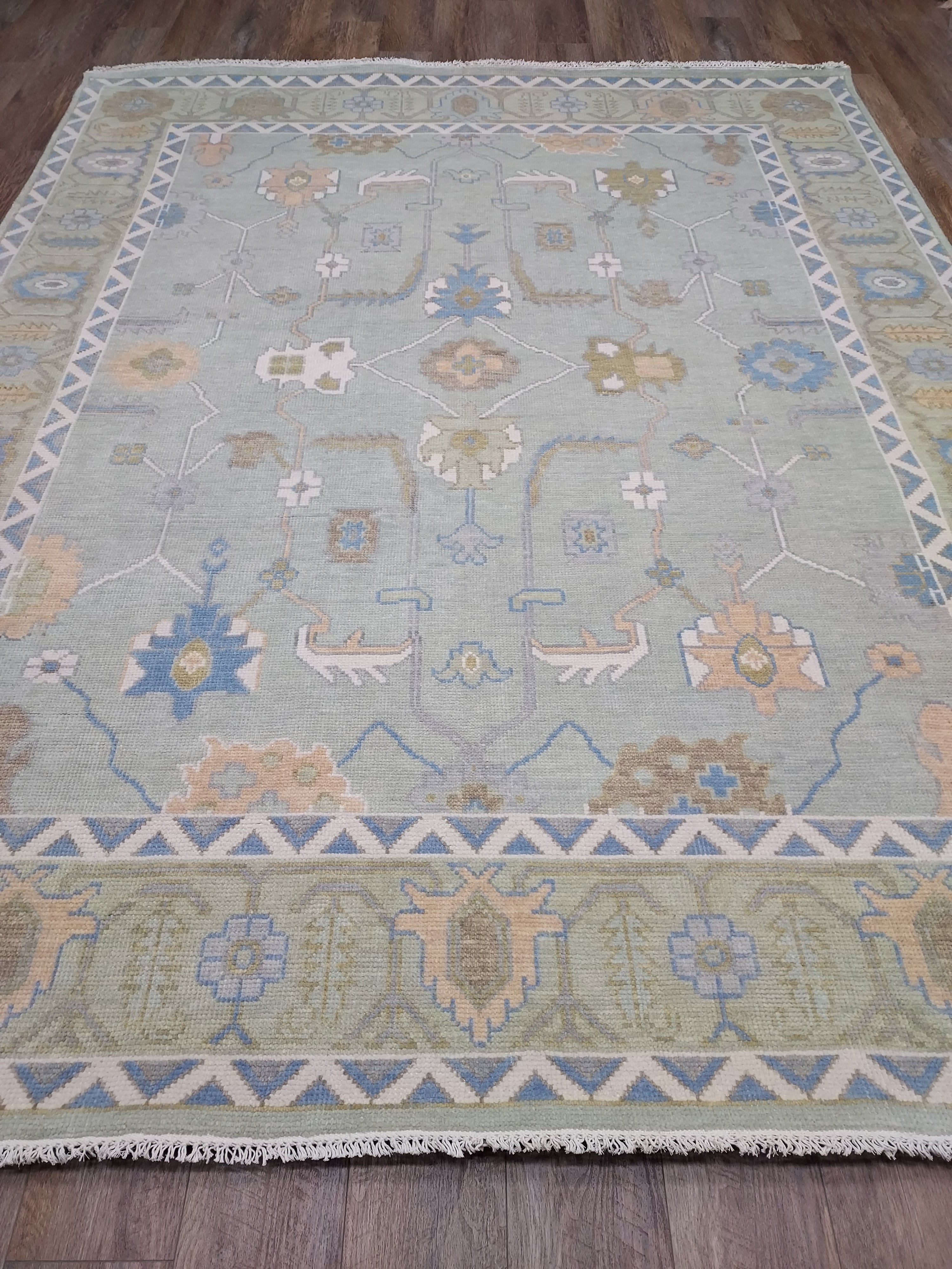 Decorative rug with intricate patterns on a wooden floor